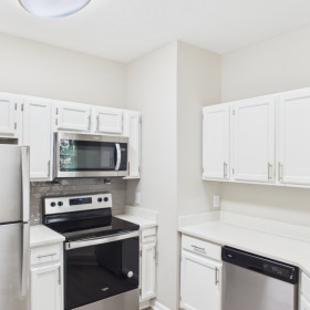 Kitchen with white walls and cabinets 