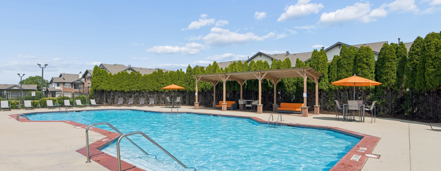 Swimming pool with sundeck and trees