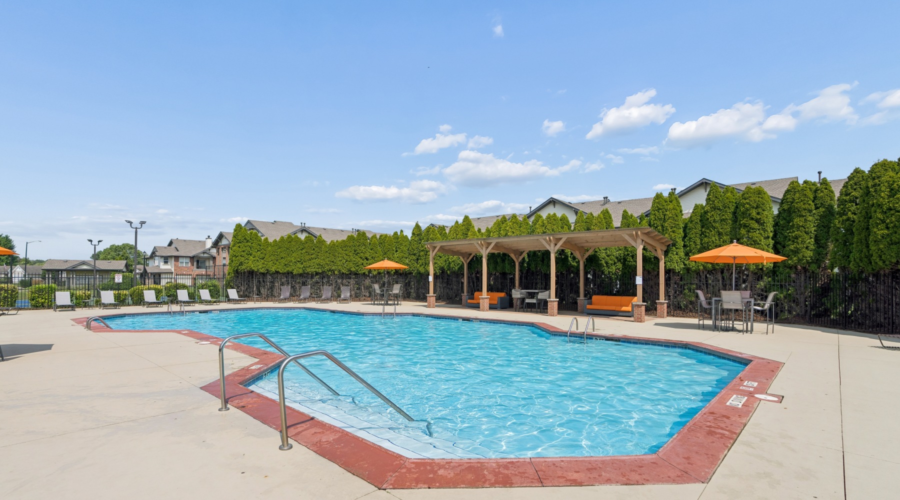 Swimming pool with sundeck and trees