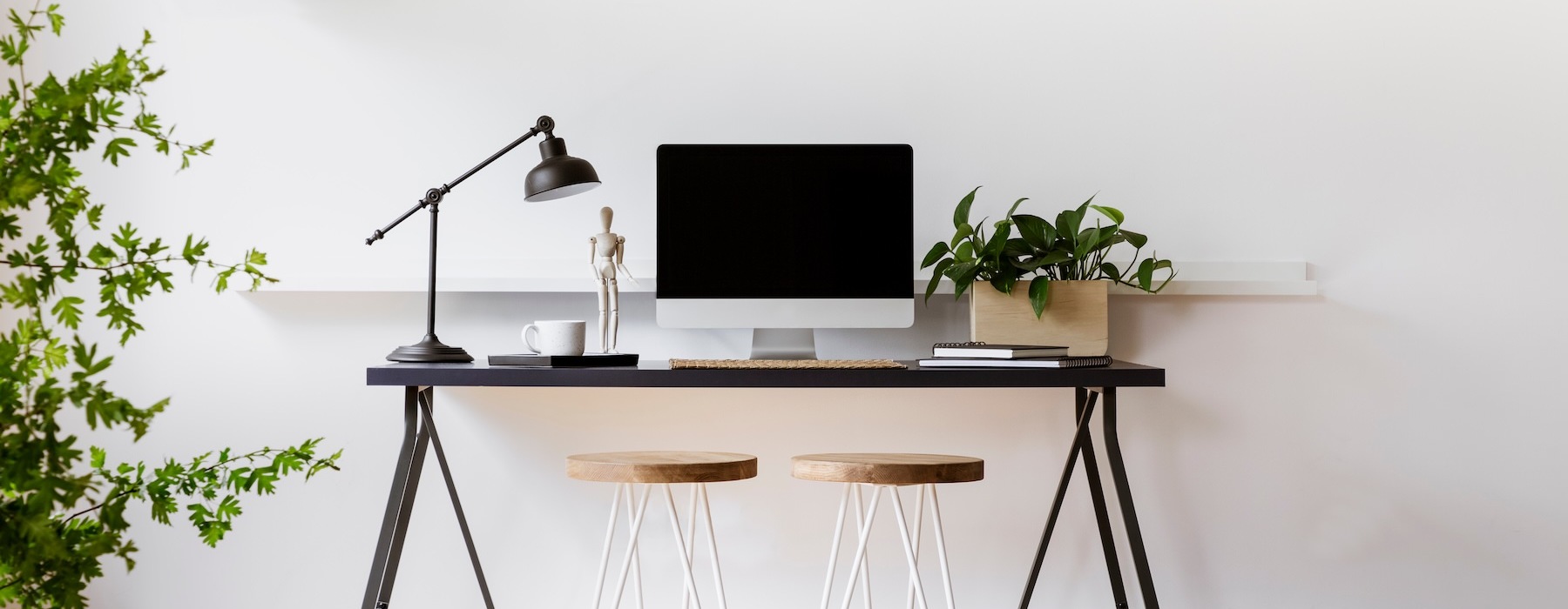 a room with a desk, chairs and a computer