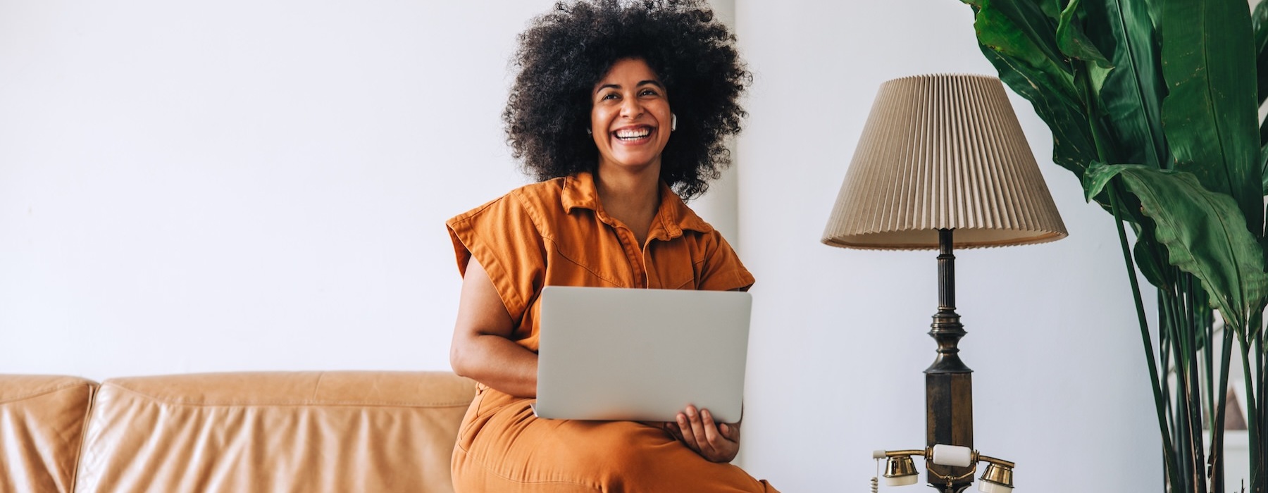 a person sitting on a couch with a laptop